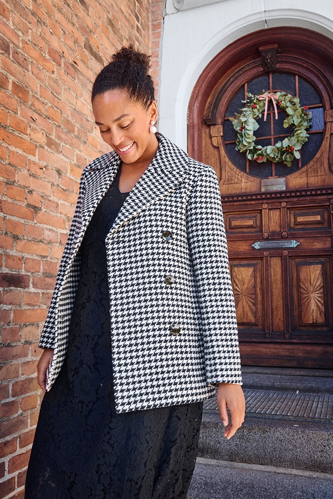 Woman in a black and white checkered jacket